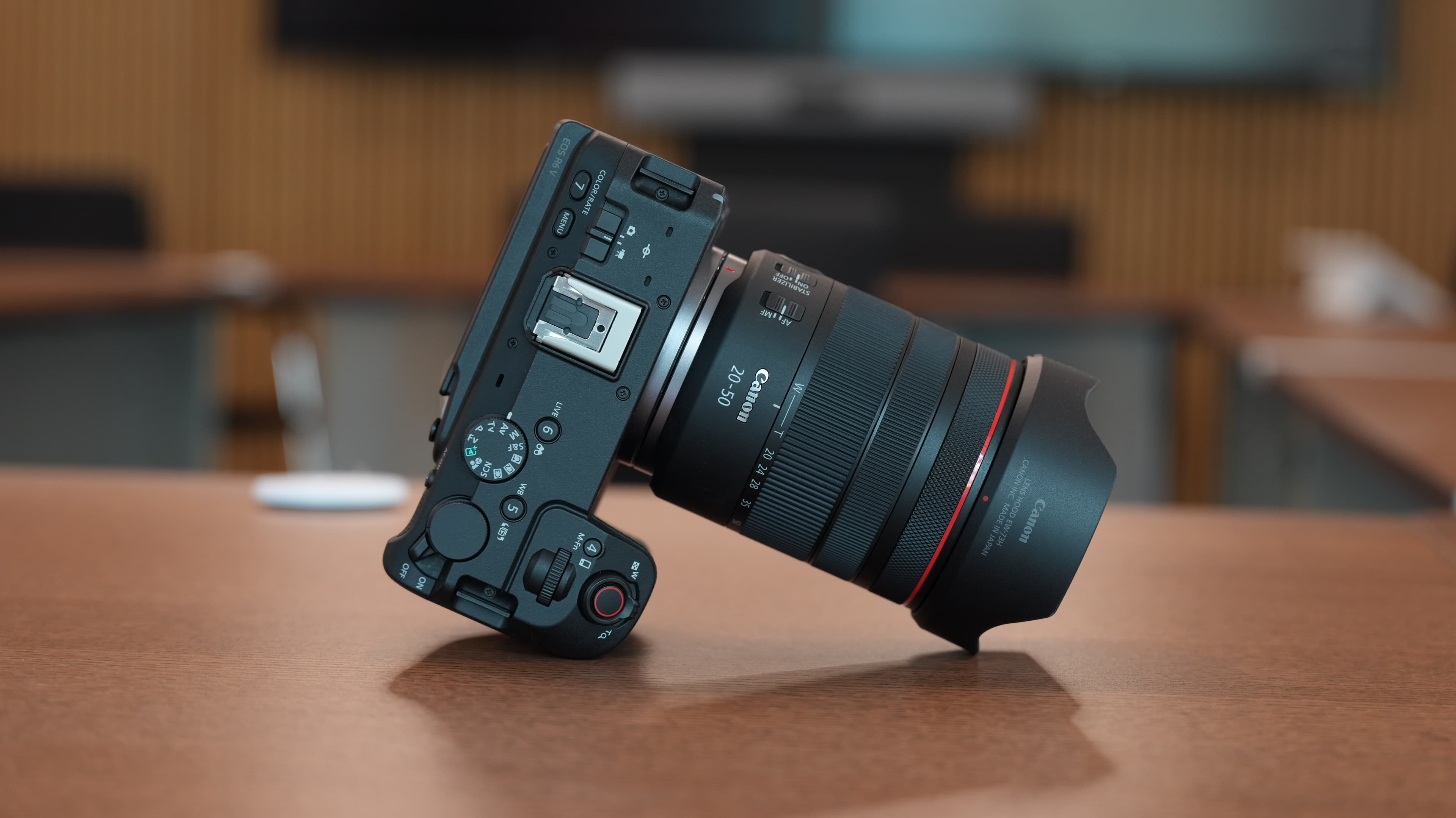 Canon RF 20-50mm f/4 L IS USM PZ lens on white background, three-quarter front view